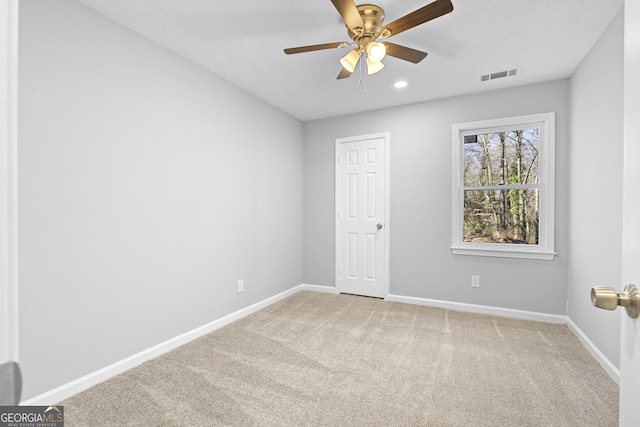 carpeted empty room with ceiling fan