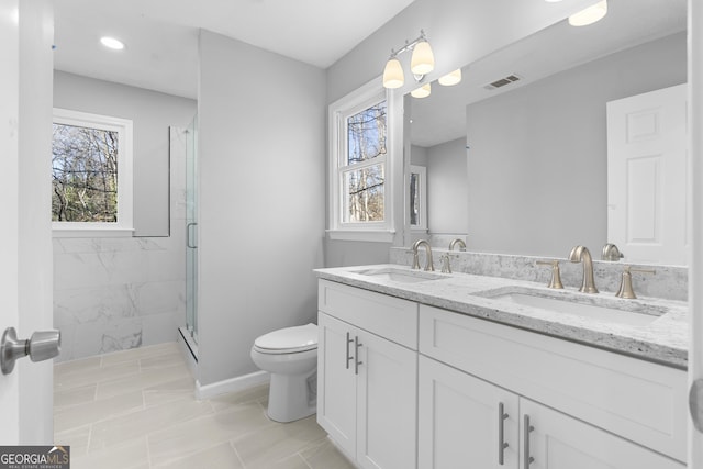 bathroom with tile patterned flooring, vanity, toilet, and an enclosed shower