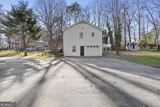 view of side of home featuring a garage and a shed