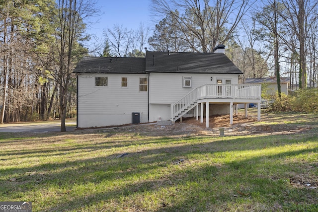 rear view of house featuring a yard, a deck, and central air condition unit