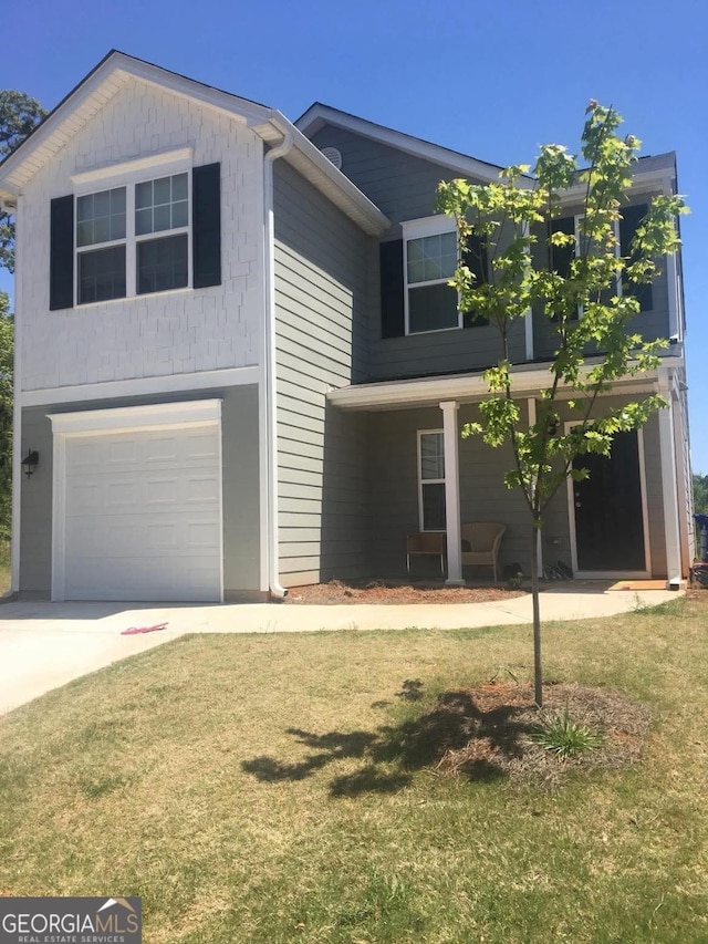 view of front of house with a garage and a front yard