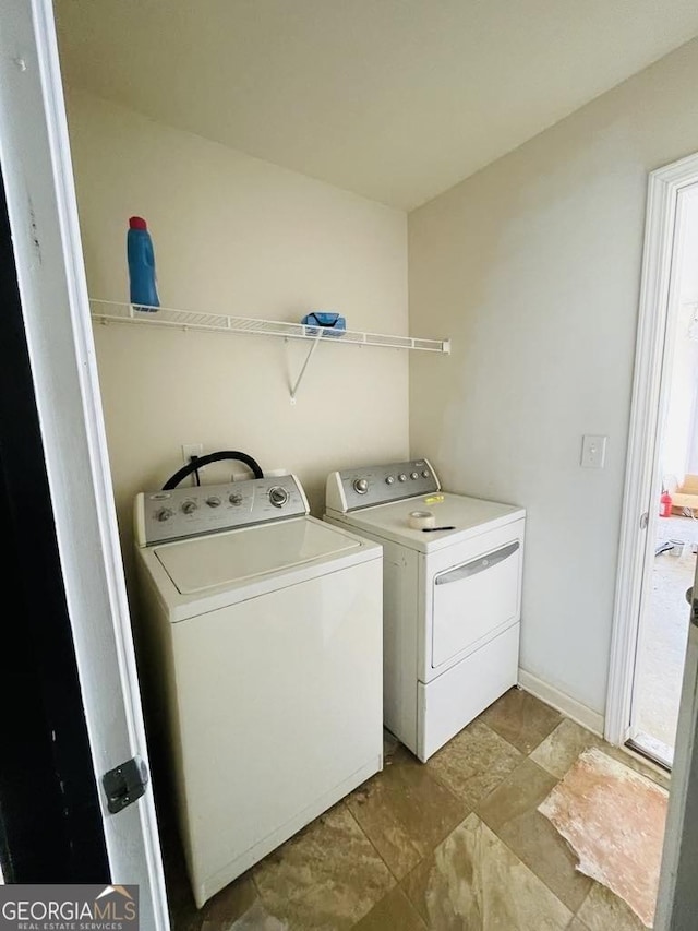 clothes washing area with washing machine and dryer