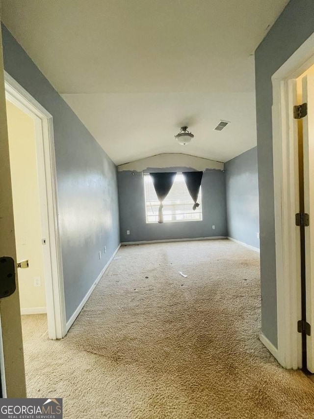 empty room with carpet and lofted ceiling