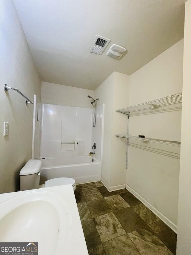 full bathroom featuring toilet, sink, and shower / washtub combination