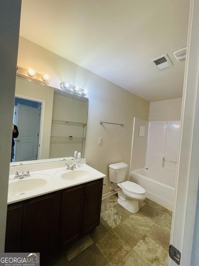 full bathroom featuring vanity, toilet, and  shower combination