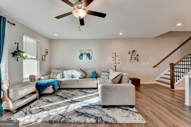 living room featuring ceiling fan and wood-type flooring