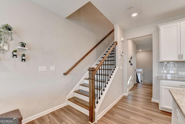 stairway featuring hardwood / wood-style flooring