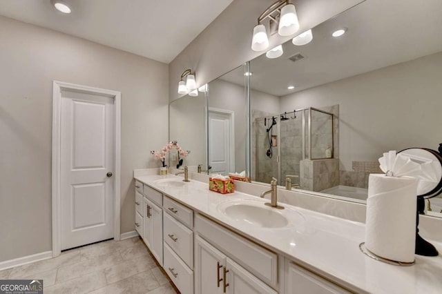 bathroom featuring tile patterned flooring, vanity, and a shower with shower door