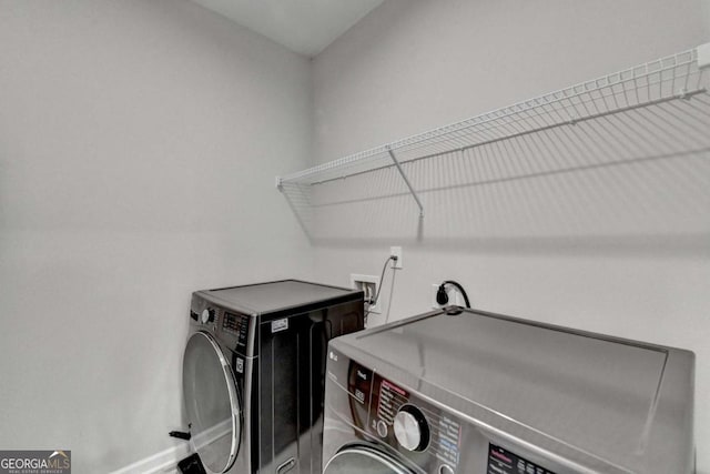 laundry room with independent washer and dryer