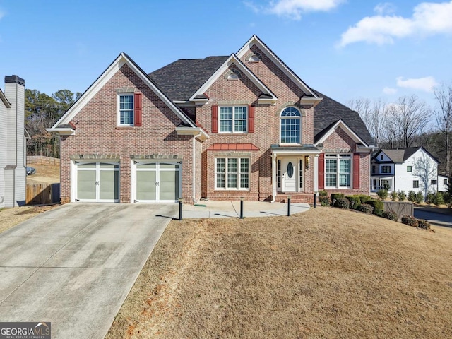 view of front of home with a front yard and a garage