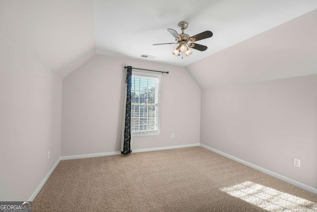 additional living space with ceiling fan, carpet, and lofted ceiling