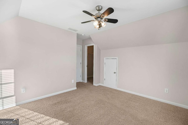 additional living space with carpet, ceiling fan, and vaulted ceiling