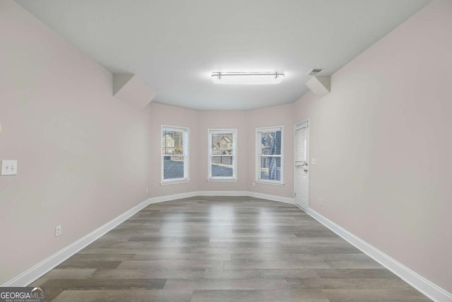 empty room with hardwood / wood-style flooring