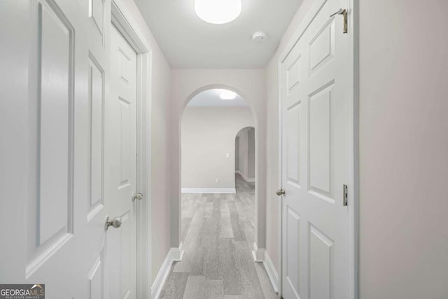 hallway with light hardwood / wood-style flooring