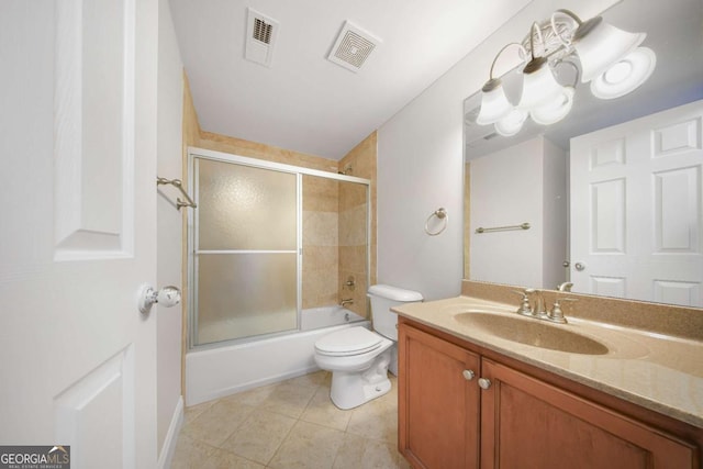 full bathroom with tile patterned flooring, toilet, combined bath / shower with glass door, and vanity