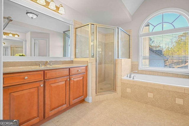 bathroom featuring tile patterned flooring, shower with separate bathtub, vanity, and lofted ceiling