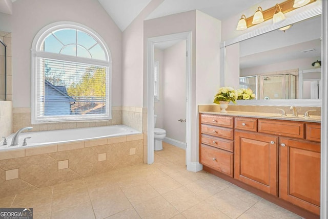 full bathroom featuring vanity, tile patterned flooring, shower with separate bathtub, toilet, and lofted ceiling