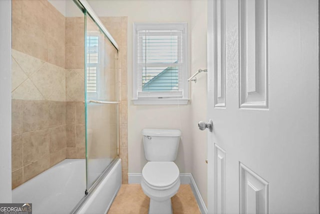 bathroom featuring combined bath / shower with glass door and toilet