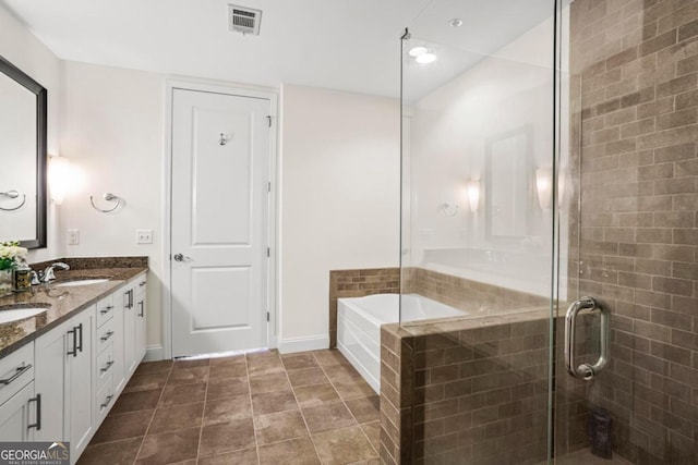 bathroom featuring shower with separate bathtub and vanity