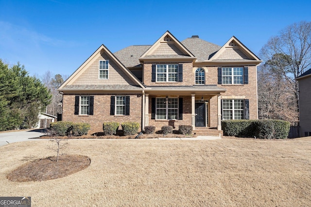 craftsman-style home with a front lawn and covered porch