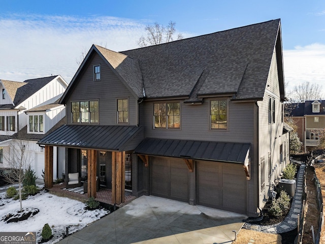 modern farmhouse style home with central AC unit, a garage, and a porch