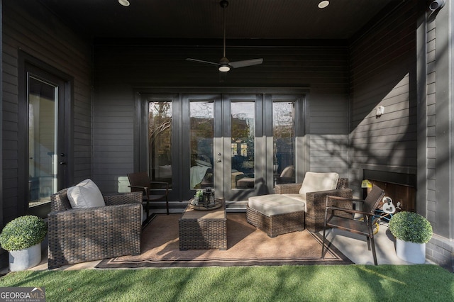 view of patio / terrace featuring ceiling fan, french doors, and an outdoor living space