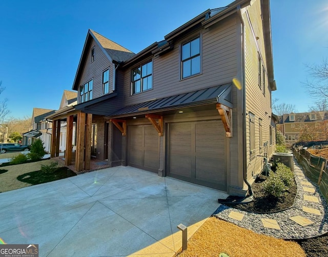 view of front of home featuring a garage and central air condition unit