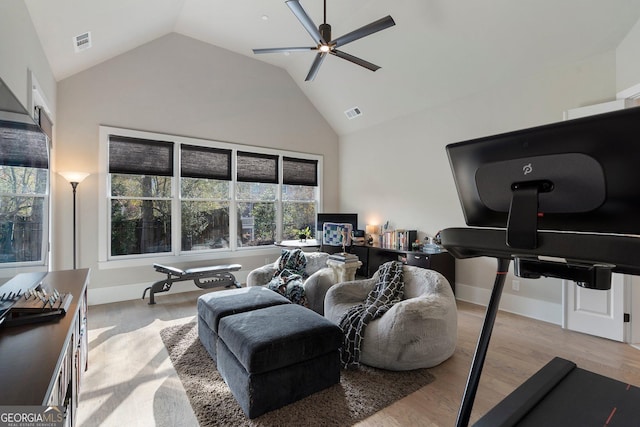 living room featuring light wood-type flooring, ceiling fan, and lofted ceiling