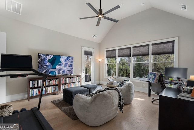 living room featuring light wood-type flooring, ceiling fan, and vaulted ceiling