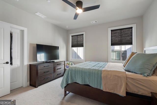 bedroom with ceiling fan and light colored carpet