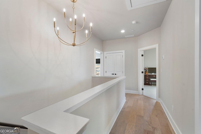 hall with a chandelier and light hardwood / wood-style flooring