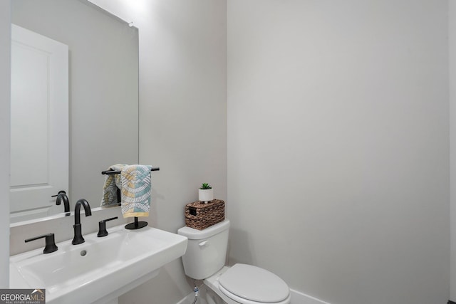 bathroom featuring toilet and sink