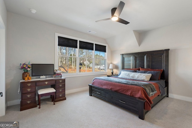 bedroom featuring ceiling fan, light colored carpet, and vaulted ceiling