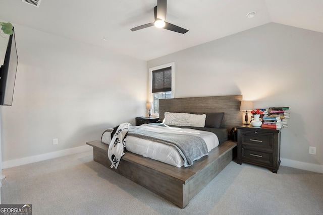 bedroom featuring ceiling fan, light carpet, and vaulted ceiling