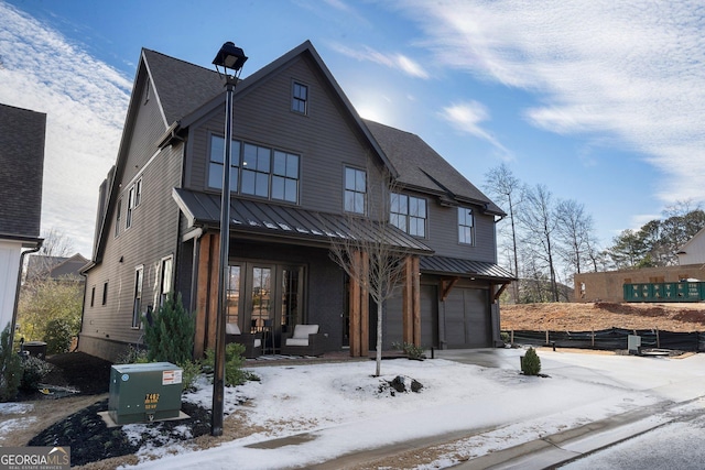 view of front of property featuring a garage and a porch