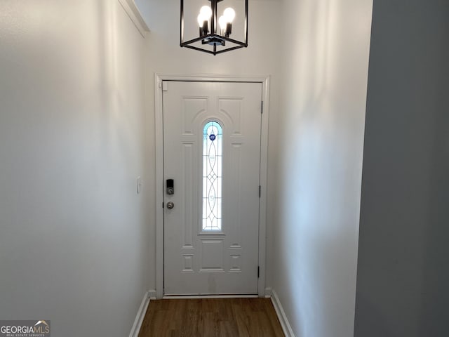 doorway featuring a notable chandelier and dark hardwood / wood-style floors