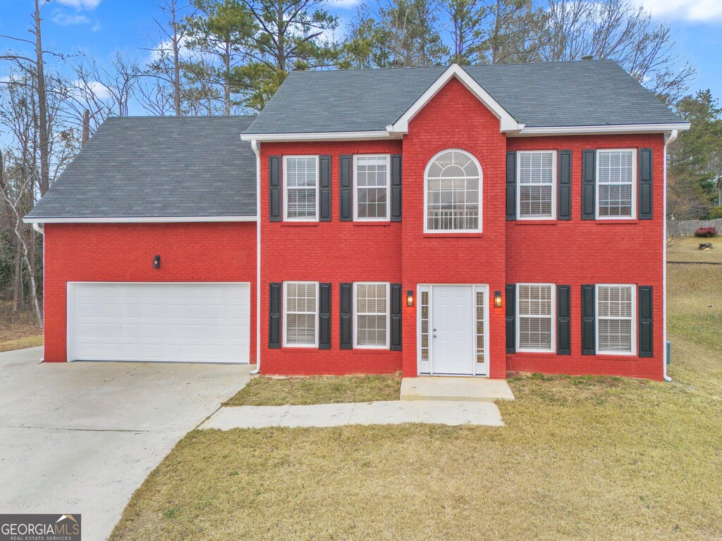 view of front facade with a front yard and a garage