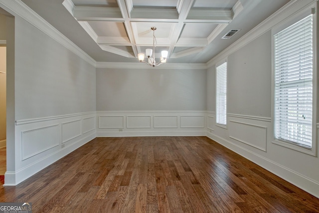 unfurnished dining area with beamed ceiling, a notable chandelier, a wealth of natural light, and coffered ceiling