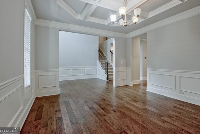 spare room with crown molding, dark wood-type flooring, coffered ceiling, and an inviting chandelier