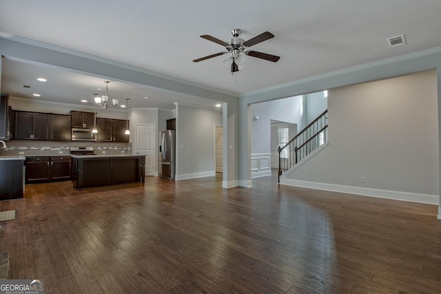 unfurnished living room featuring ceiling fan with notable chandelier, dark hardwood / wood-style floors, and crown molding