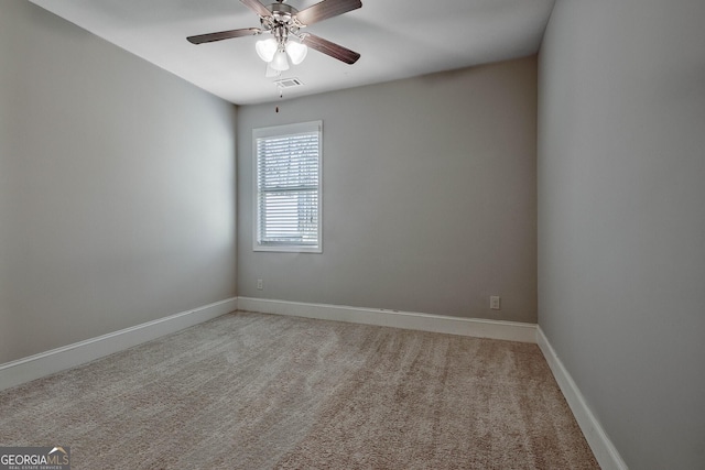 carpeted empty room featuring ceiling fan