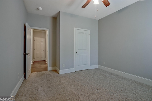 unfurnished bedroom featuring ceiling fan and light carpet