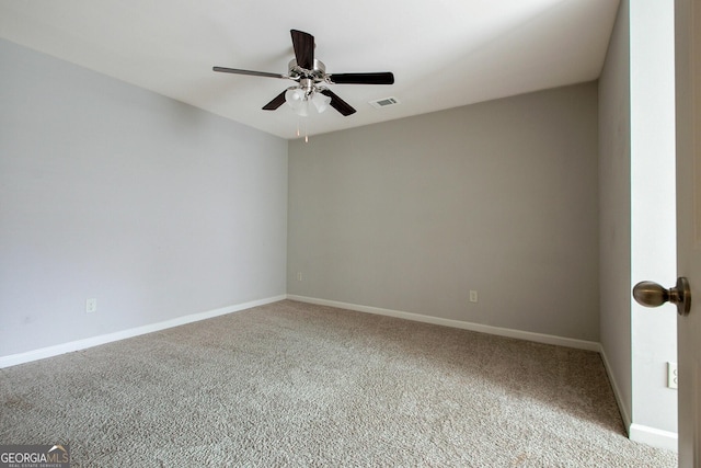 carpeted spare room with ceiling fan