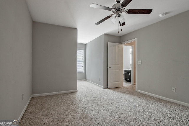 empty room featuring ceiling fan and light carpet