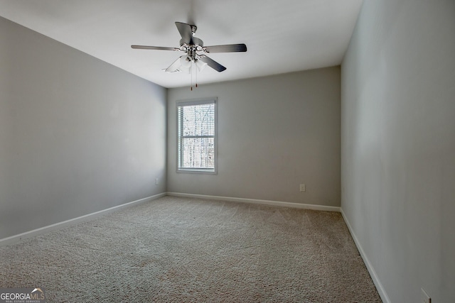 carpeted spare room featuring ceiling fan