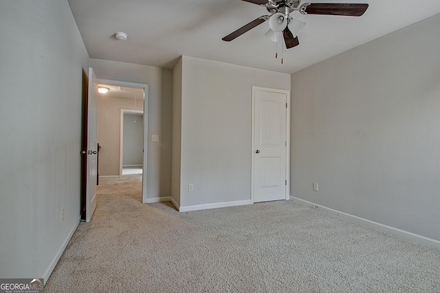 unfurnished bedroom with ceiling fan and light carpet