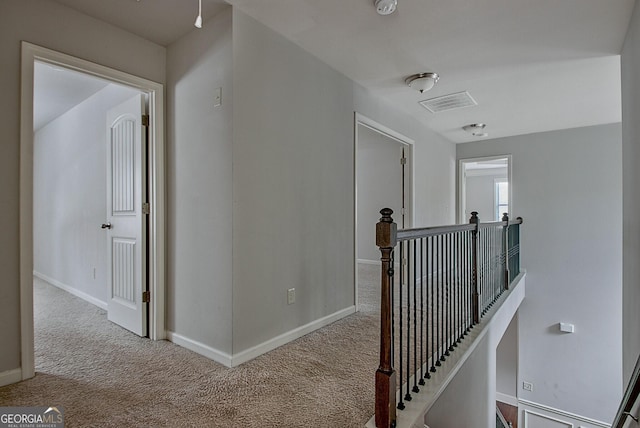 hallway with light colored carpet