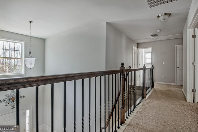 hall featuring light colored carpet