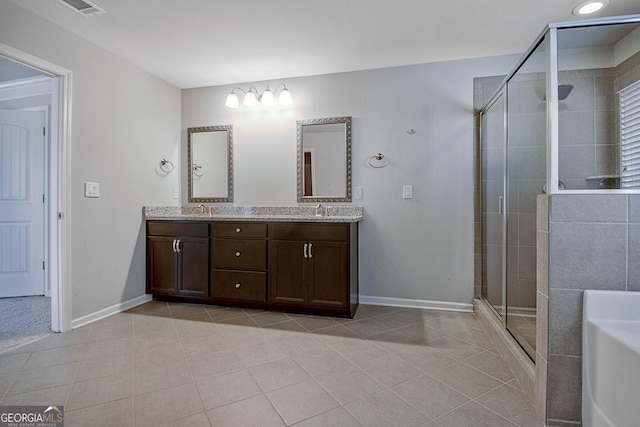 bathroom featuring tile patterned floors, vanity, and walk in shower