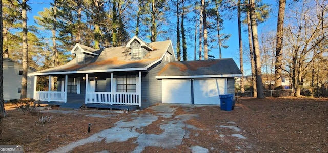 view of front of home featuring a porch and a garage